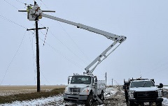 Crews work to restore power after a wet, heavy spring snowstorm.