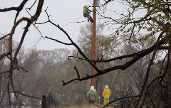 Crews work to restore power after a wet, heavy spring snowstorm.