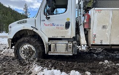 Crews work to restore power after an outage caused by wet, heavy spring snow.
