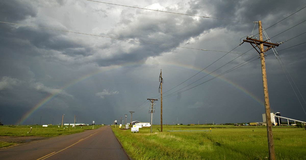 A rainbow over power lines.