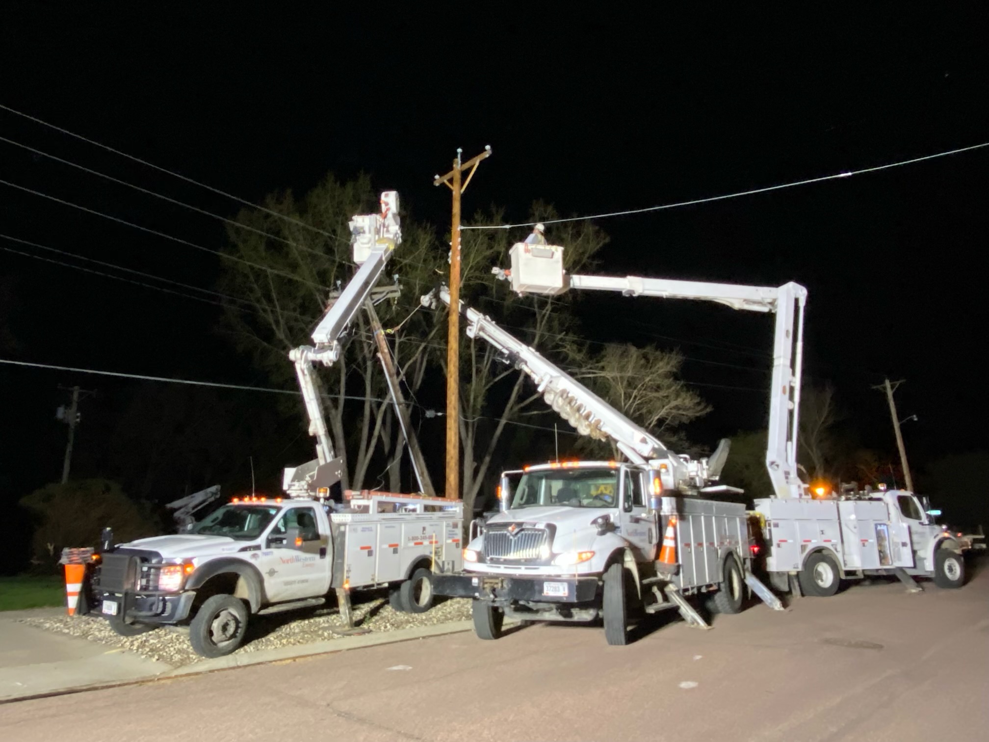 NorthWestern Energy crew servicing power lines at night